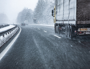 Truck driving on winter weather highway