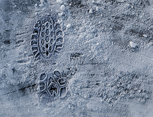 Footprint on snowy sidewalk